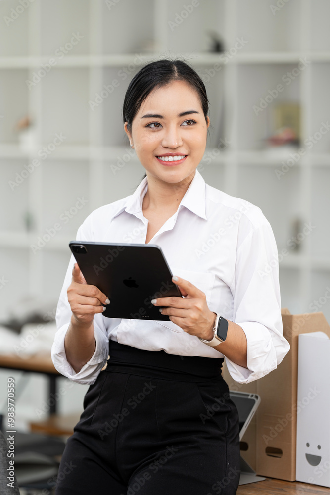 Asian business woman using digital tablet and laptop computer, working at office. Asian business woman using digital tablet and laptop computer, working at office.