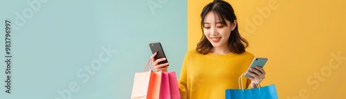 Happy woman with shopping bags looking at smartphone photo