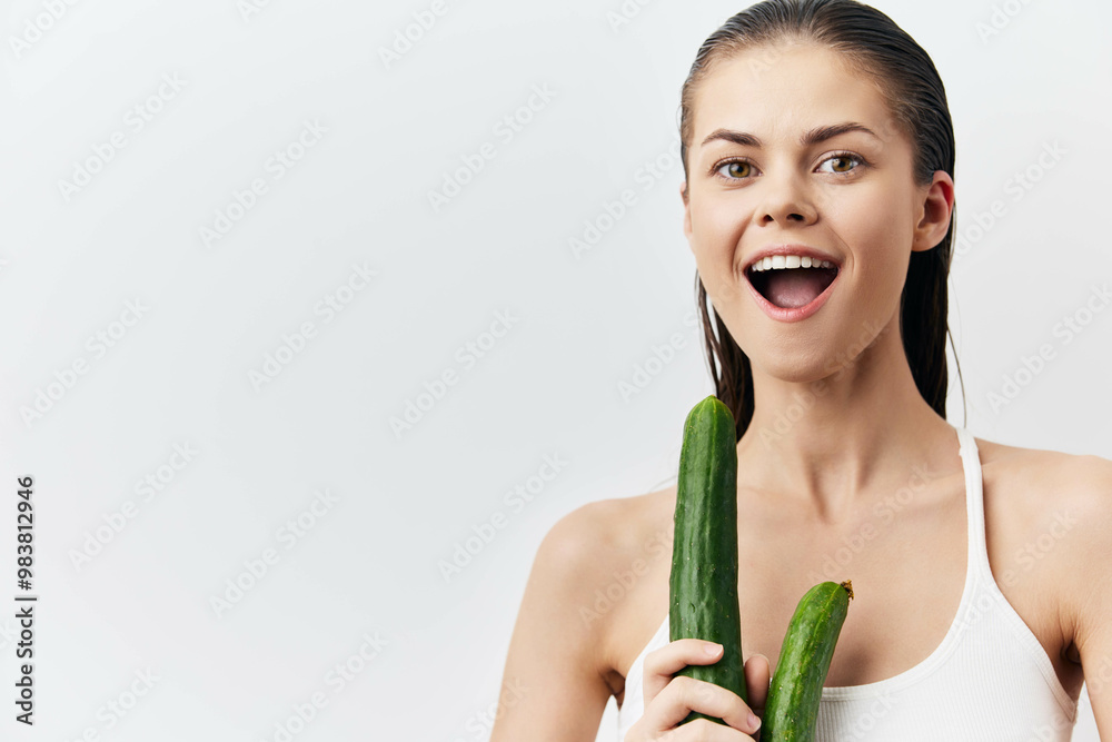 Woman holding cucumbers with a joyful expression, fresh and healthy lifestyle Bright background enhances the vibrant mood Ideal for wellness and nutrition themes Woman holding cucumbers with a joyful expression, fresh and healthy lifestyle Bright background enhances the vibrant mood Ideal for wellness and nutrition themes