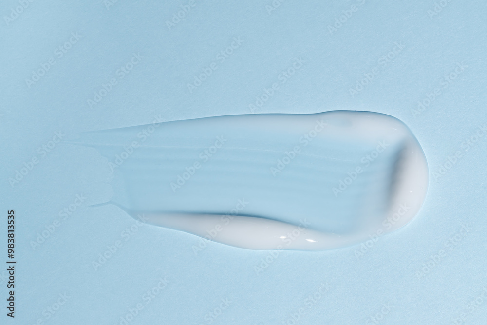 Cream face cream texture stroke. Facial cream swatches. body cream cosmetic product smear swatch on blue background Cream face cream texture stroke. Facial cream swatches. body cream cosmetic product smear swatch on blue background