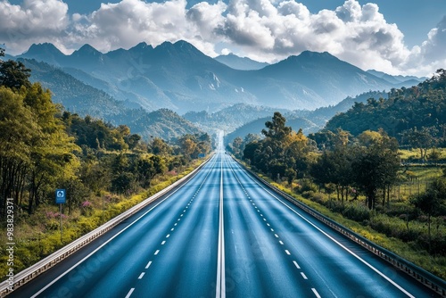 A Straight Highway Through Rolling Hills and a Cloudy Sky