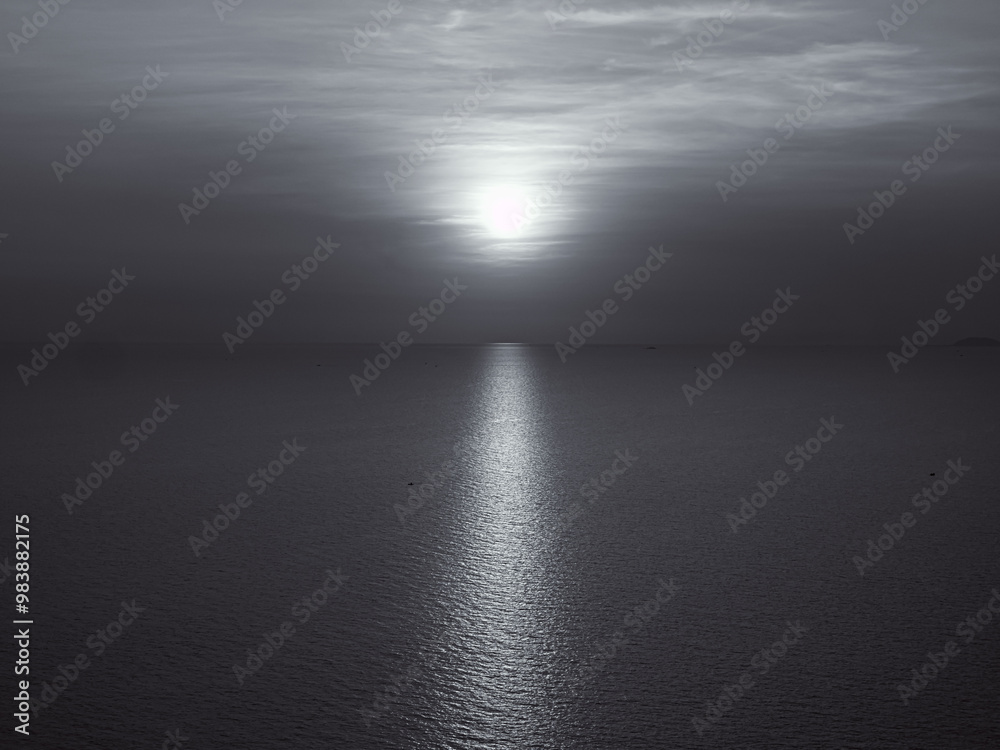 Serene Monochrome Sunset Over Calm Ocean Waters Serene Monochrome Sunset Over Calm Ocean Waters