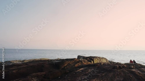 Sunset at ocean at Kappad Beach Kozhikode Kerala India in background of rocks video beautiful colorful sky  photo