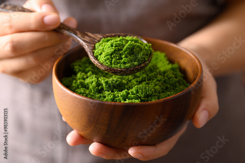 Schilderij op canvas Wolffia or watermeal in wooden bowl with spoon holding by hand, Edible small aqu