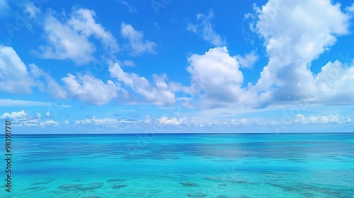 A beautiful scene of the blue ocean against the blue sky background. The ocean stretches out as far as the eye can see, with its surface glistening in the sunlight photo