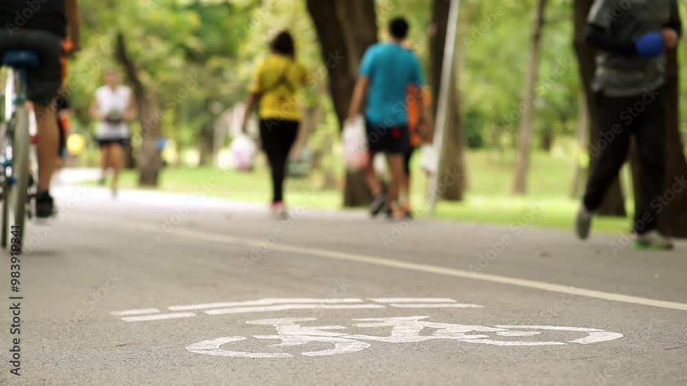 custom made wallpaper toronto digitalA peaceful weekend morning scene featuring a crowd of people exercising and riding bikes through a lush park. Soft sunlight filters through trees, creating a calm, active atmosphere