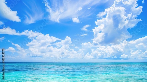 A beautiful scene of the blue ocean against the blue sky background. The ocean stretches out as far as the eye can see, with its surface glistening in the sunlight