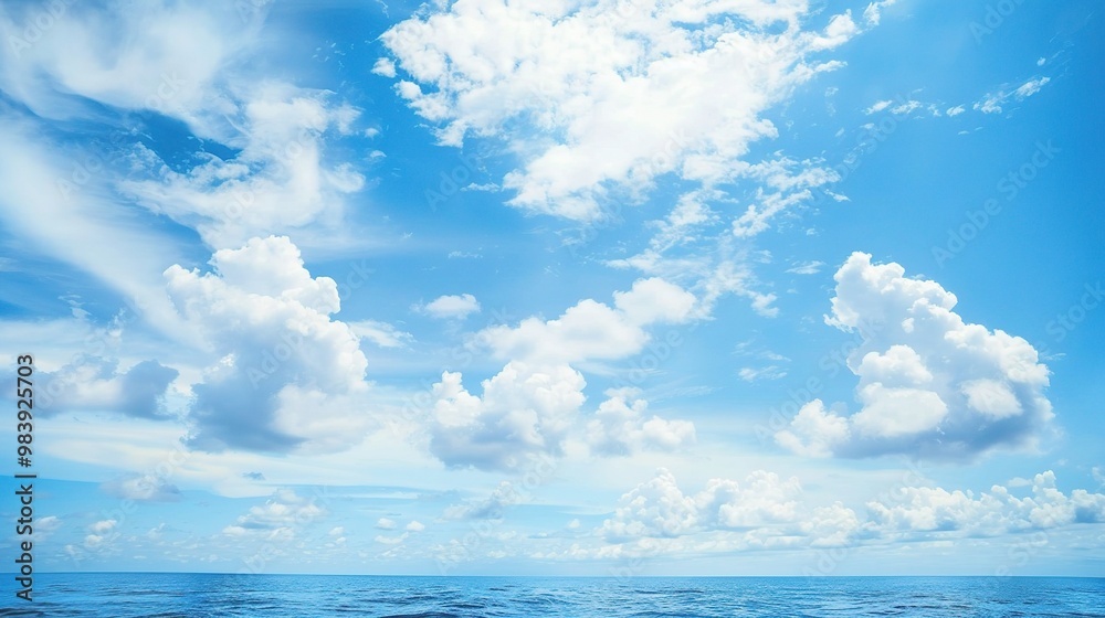 A beautiful scene of the blue ocean against the blue sky background. The ocean stretches out as far as the eye can see, with its surface glistening in the sunlight A beautiful scene of the blue ocean against the blue sky background. The ocean stretches out as far as the eye can see, with its surface glistening in the sunlight