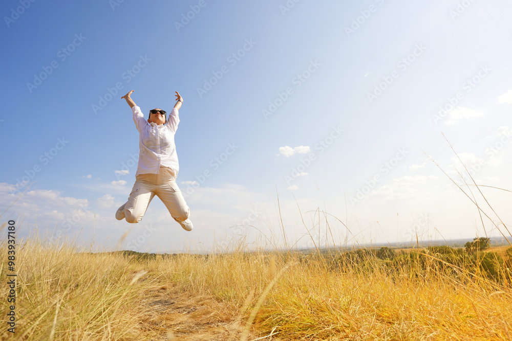A charming girl enjoys the wind, smile and freedom, sunset and autumn light. Beautiful lady having fun in nature and jumps. A charming girl enjoys the wind, smile and freedom, sunset and autumn light. Beautiful lady having fun in nature and jumps.