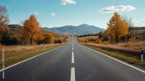 Scenic Autumn Road Through Mountains and Fields