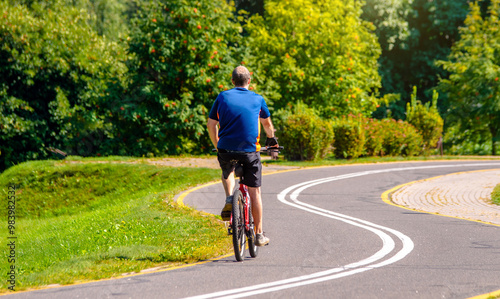 Wallpaper Mural Cyclist ride on the bike path in the city Park
 Torontodigital.ca