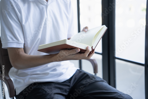 man is holding notebook and pen writing moment of creativity or documentation