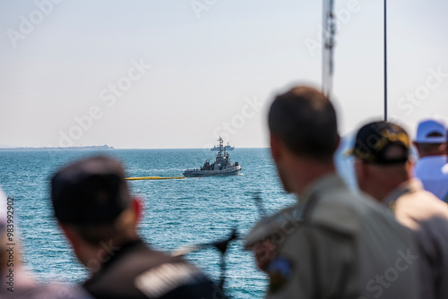 marines in white uniforms and officers on a battleship. combat scientists at sea. war in ukraine and black sea. old russian ships. military sailors talking on radios, watching other ships. military po