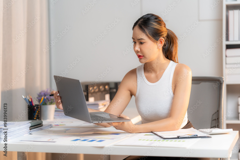 Focused Female Entrepreneur Analyzing Data at Home Office Focused Female Entrepreneur Analyzing Data at Home Office