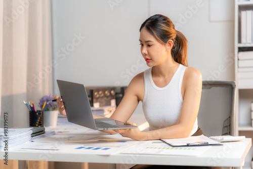 Focused Female Entrepreneur Analyzing Data at Home Office 