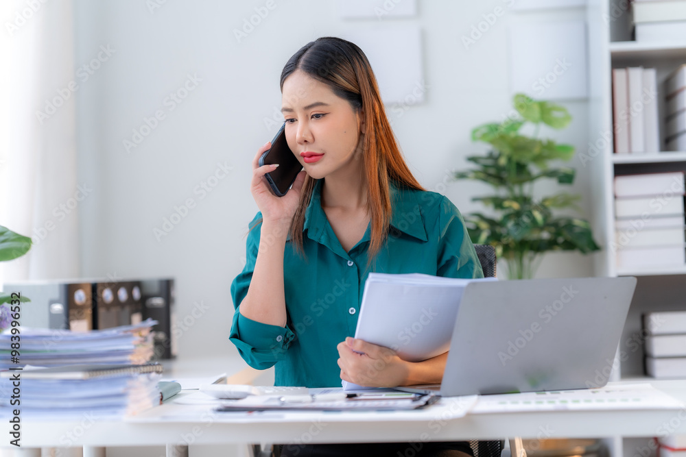 Focused Asian Businesswoman Multitasking at Work Focused Asian Businesswoman Multitasking at Work