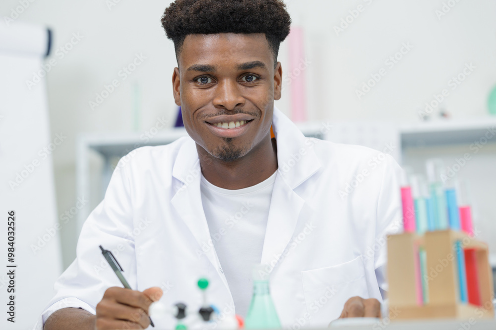 smiling lab technician doing water analysis smiling lab technician doing water analysis