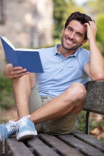 happy man reading a book in the park