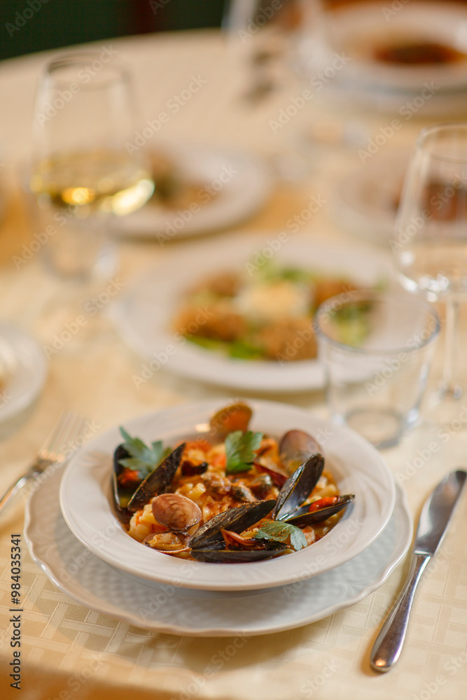 Close up on italian traditional northern food on a restaurant table. Seafood pasta recipe.