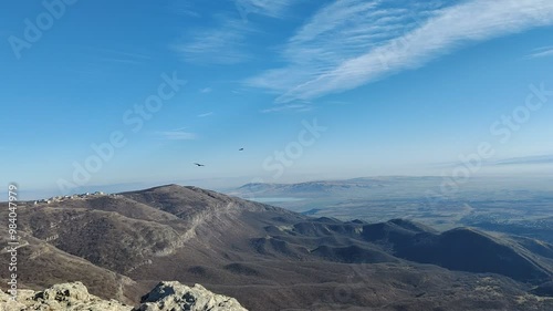Eagles flying over mountains against blue sky. The birds are flying. Birds fly and circle in the air