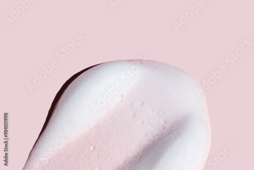 Creamy cosmetic texture on a pink background