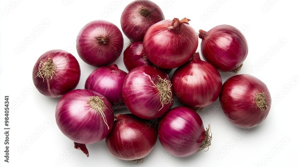 Red onions, seen from above, against a plain white backdrop. Red onions, seen from above, against a plain white backdrop.