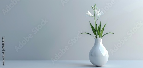 A beautiful white flower arrangement in a sleek vase against a minimalist background.