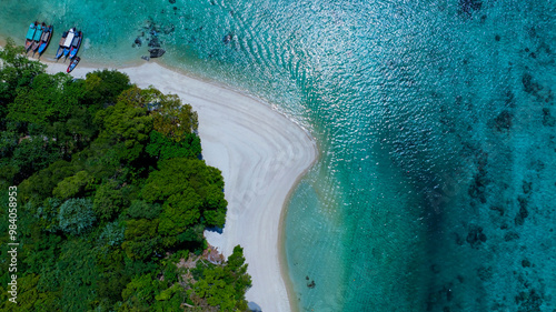 The aerial view of white sand beach tropical with seashore as the island in a coral reef ,blue and turquoise sea Amazing nature landscape with blue lagoon photo