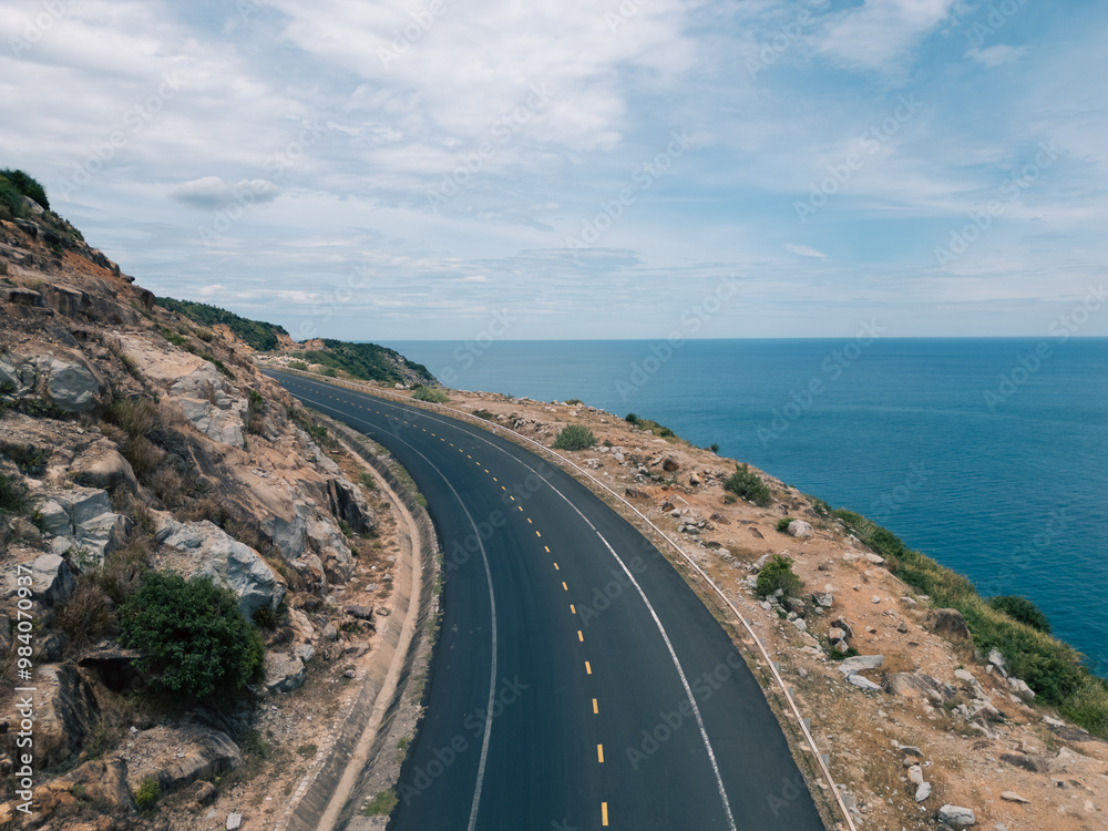 Aerial view of nobody on beach with beautiful sea view. Royalty high-quality free stock image top view adventure road trip between mountain rock and ocean. Driving road along, traveling Aerial view of nobody on beach with beautiful sea view. Royalty high-quality free stock image top view adventure road trip between mountain rock and ocean. Driving road along, traveling