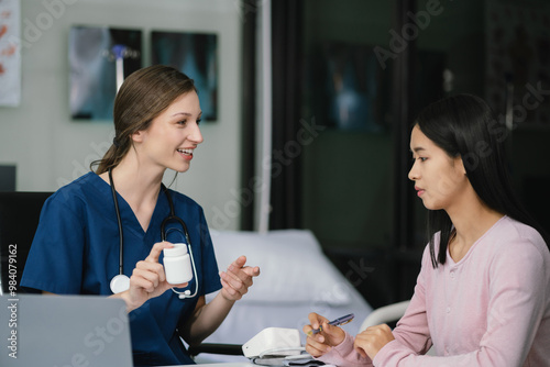 medicine, healthcare and people concept - doctor with tablet pc computer talking to woman patient at hospital.