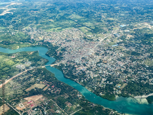 aerial landscape view of area around City of Mtwapa in Kenya, located north of Mombasa at east coast on Indian Ocean and Mtwapa Bridge crossing the Mtwapa Creek and cityscape from bird eyes view 
 photo