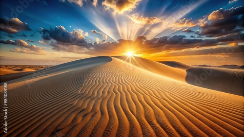 Asymmetrical sand dune at sunset with beam of light on immaculate pattern