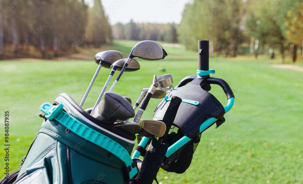 Naklejka premium Golf clubs and bag resting on a green fairway in a serene park during a sunny afternoon concept