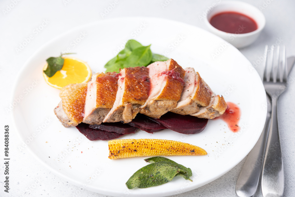 Files of the breast duck grill with beets, mini corn and spinach, fried sage, orange and lingonberry sauce. Traditional Mediterranean cuisine. Selective focus, close-up. Files of the breast duck grill with beets, mini corn and spinach, fried sage, orange and lingonberry sauce. Traditional Mediterranean cuisine. Selective focus, close-up.