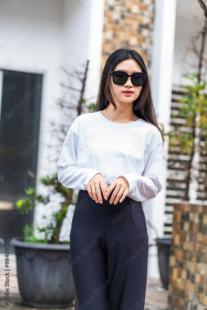 Fototapeta premium Young Woman in White Long Sleeve Shirt and Glasses Posing for Outdoor Mockup