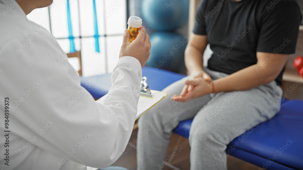 Doctor consulting male patient with medication in hospital room, portraying healthcare and professional advice. Doctor consulting male patient with medication in hospital room, portraying healthcare and professional advice.