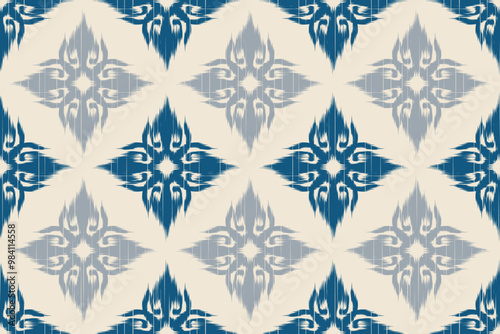 Traditional seamless blue and grey ikat fabric pattern with floral motifs for fabric, wallpaper and textiles. Ethnic and tribal repetitive design with symmetrical geometric elements.