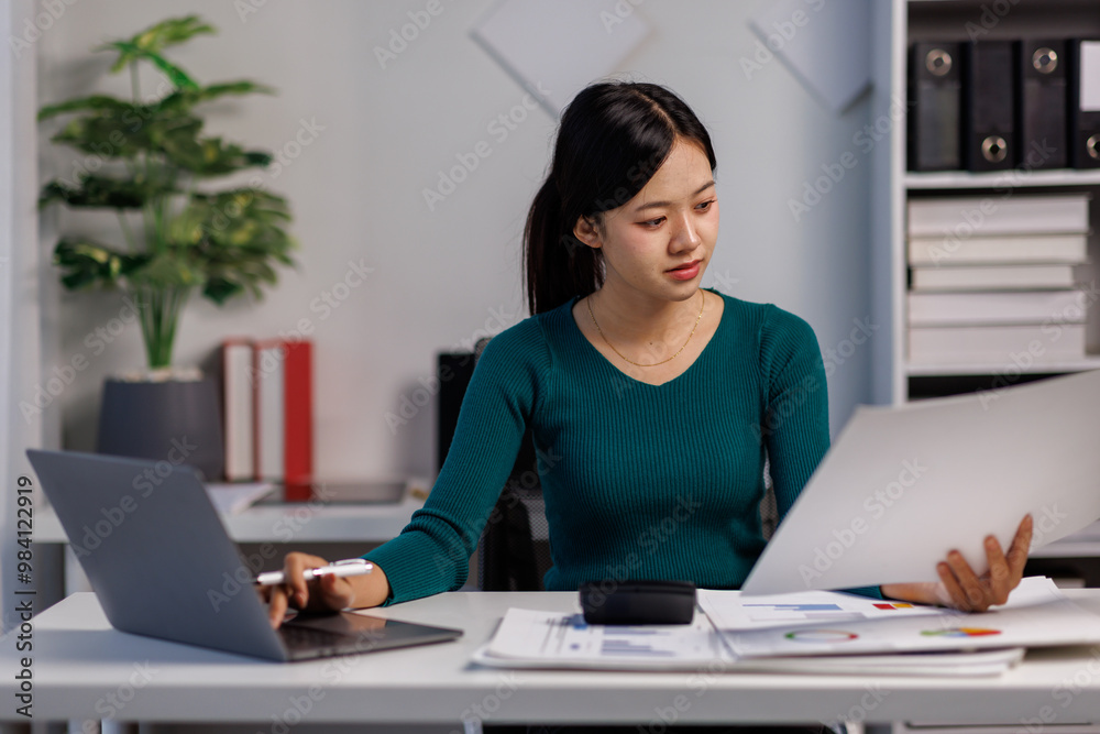 Accountant working on desk using laptop documents calculator to calculate financial report in office business accounting finance concept
Accountant working on desk using laptop documents calculator to calculate financial report in office business accounting finance concept
