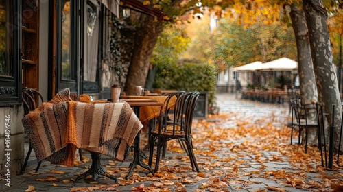 Outdoor cafe seating with blankets on the chairs