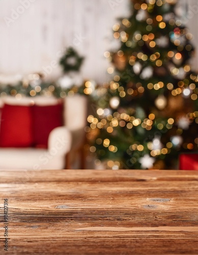 Close-up of an empty wooden table, background of a house decorated for Christmas, copy space on a side