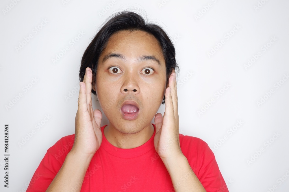 Portrait of an Indonesian man with long hair with a headband and red shirt celebrating Indonesian Independence Day with high nationalism on an isolated white background Portrait of an Indonesian man with long hair with a headband and red shirt celebrating Indonesian Independence Day with high nationalism on an isolated white background