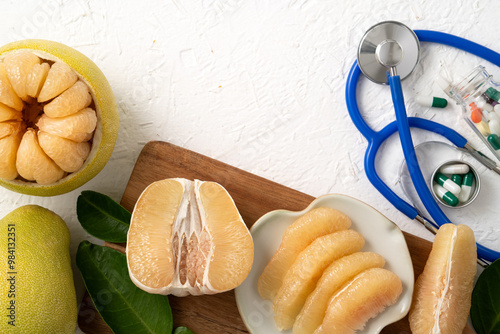 Fresh pomelo fruit and medicine adverse drug reaction interaction design concept.