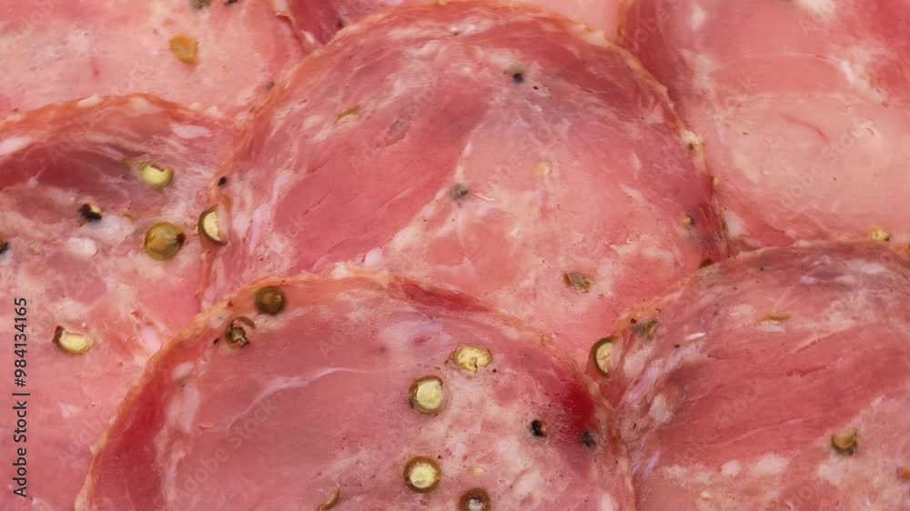 Fresh slices smoked sausage with peppercorns, rotate. Meat background. Kindyuk sausage, Turning. Fresh slices smoked sausage with peppercorns, rotate. Meat background. Kindyuk sausage, Turning.
