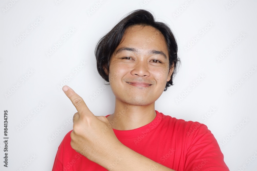 Portrait of an Indonesian man with long hair with a headband and red shirt celebrating Indonesian Independence Day with high nationalism on an isolated white background Portrait of an Indonesian man with long hair with a headband and red shirt celebrating Indonesian Independence Day with high nationalism on an isolated white background