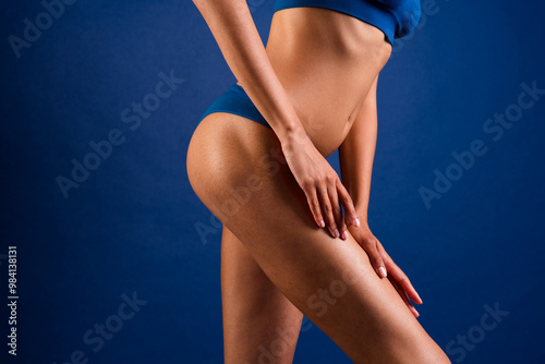 Cropped photo of young girl touch hips legs laser depilation model dressed stylish underwear no filter isolated on dark blue background photo