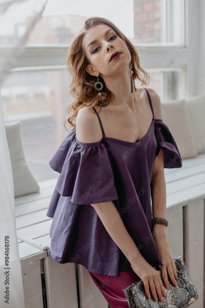 Portrait of a beautiful girl with makeup in a purple dress. Portrait of a beautiful girl with makeup in a purple dress.