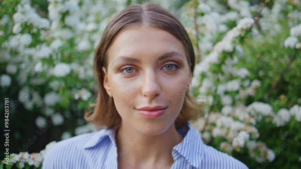 Portrait dreamy woman looking camera amidst garden bloom. Romantic brunette Portrait dreamy woman looking camera amidst garden bloom. Romantic brunette