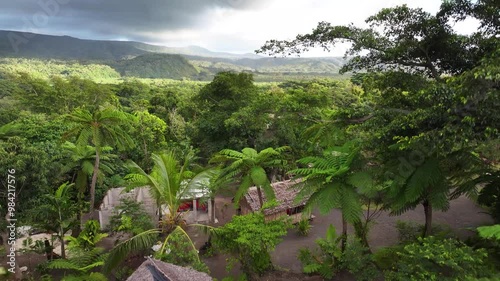 Traditional village in tropical rainforest located on active volcano, Tanna Island, Vanuatu. Aerial crane photo