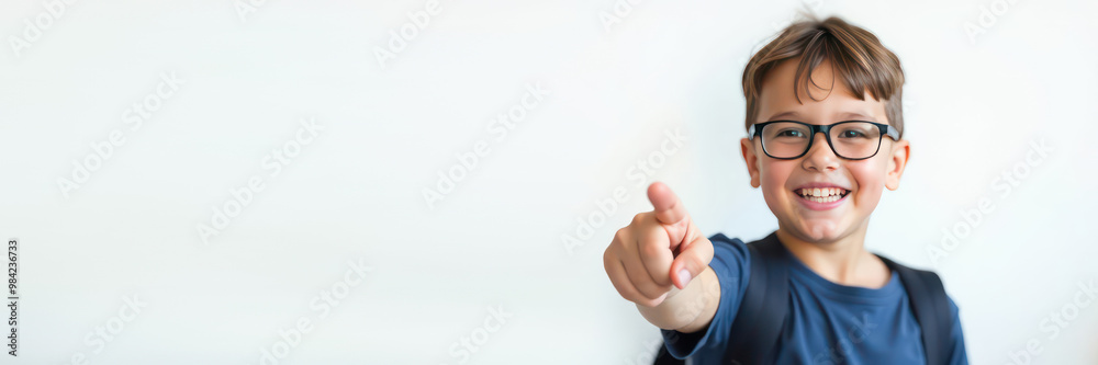 banner little boy (10 years old, smile, looking at camera, deep blue t-shirt, glasses, backpack), pupil points with her finger to the side on white background, hand pointing empty place banner little boy (10 years old, smile, looking at camera, deep blue t-shirt, glasses, backpack), pupil points with her finger to the side on white background, hand pointing empty place