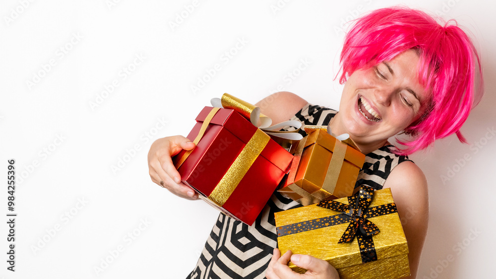 Caucasian woman in a pink wig joyfully holding Christmas gifts, celebrating holiday cheer against a plain white background Caucasian woman in a pink wig joyfully holding Christmas gifts, celebrating holiday cheer against a plain white background